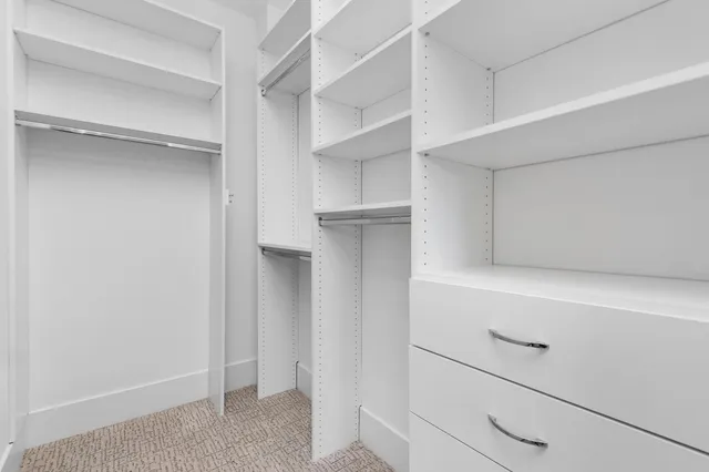 a bathroom with a glass shower door a sink and a mirror