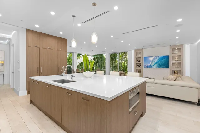 a large white kitchen with a large window