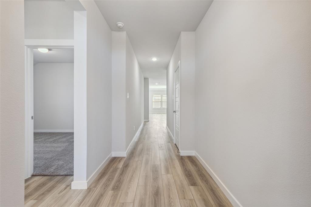 6029 Silverstein Street Fort Worth, TX 76126 - Photo 1 of 1 a view of a hallway with wooden floor