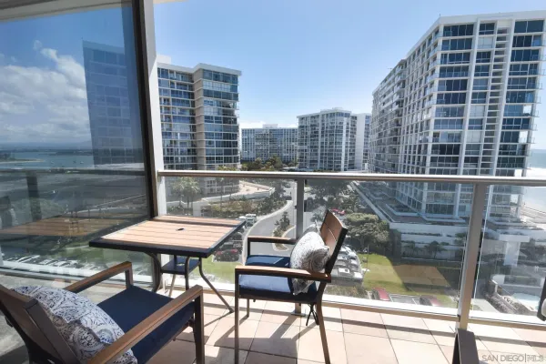 a balcony with table and chairs