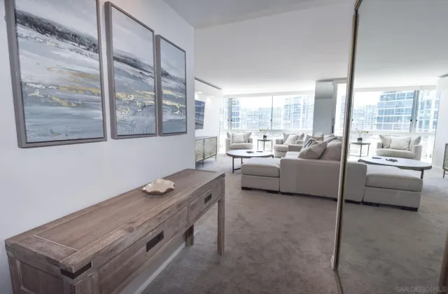 a living room with furniture and a floor to ceiling window