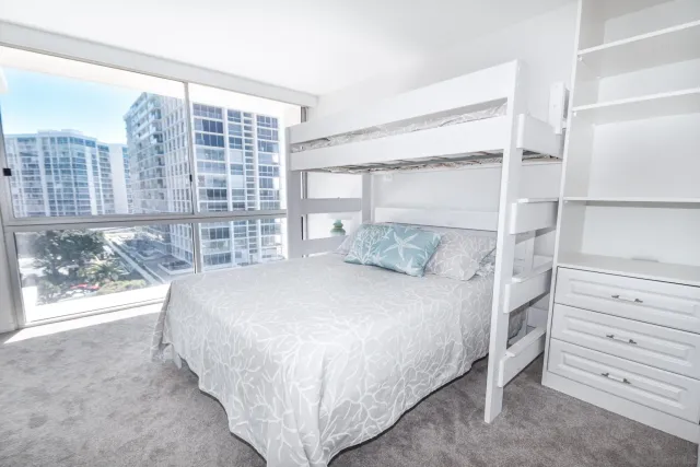 a bed sitting in a bedroom next to a window