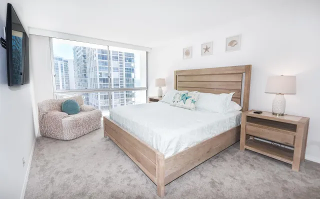 a bedroom with bed and a large window