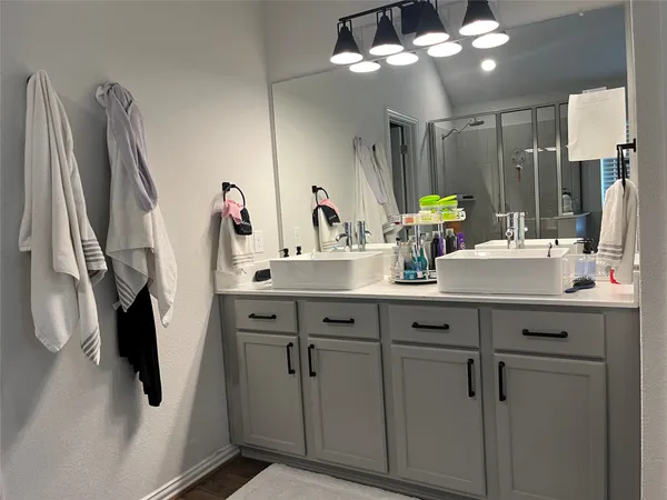 a bathroom with a double vanity sink a vanity and a mirror