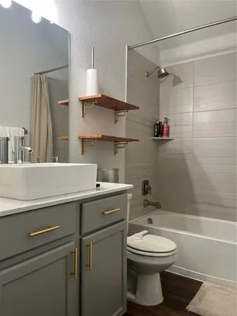 a bathroom with a sink toilet and shower