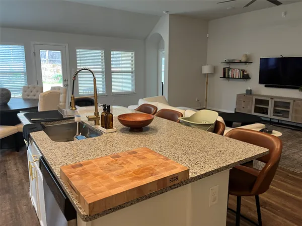 a kitchen with granite countertop a sink and a stove