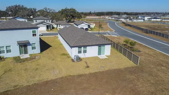 an aerial view of a house with a lake view