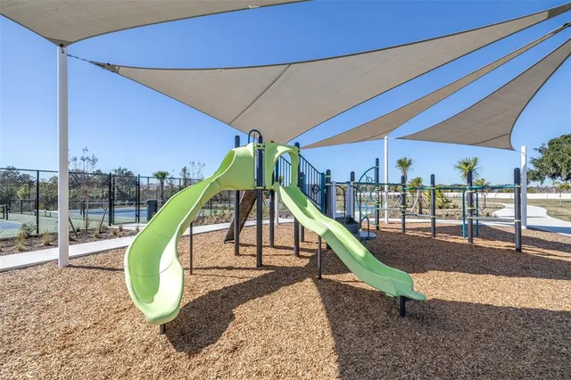 a view of a house with swimming pool and sitting area