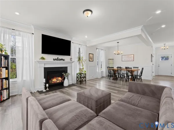 a living room with furniture a flat screen tv and a fireplace
