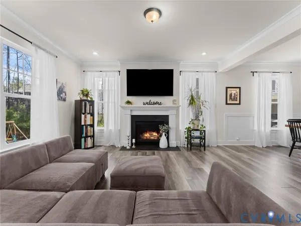 a living room with furniture and kitchen view