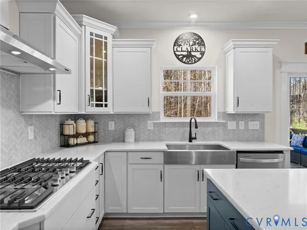 a kitchen with stainless steel appliances granite countertop a sink a stove and a refrigerator