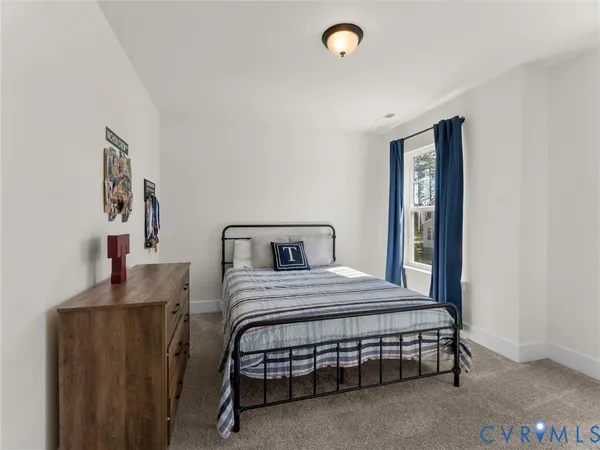 a spacious bedroom with a bed and a couch