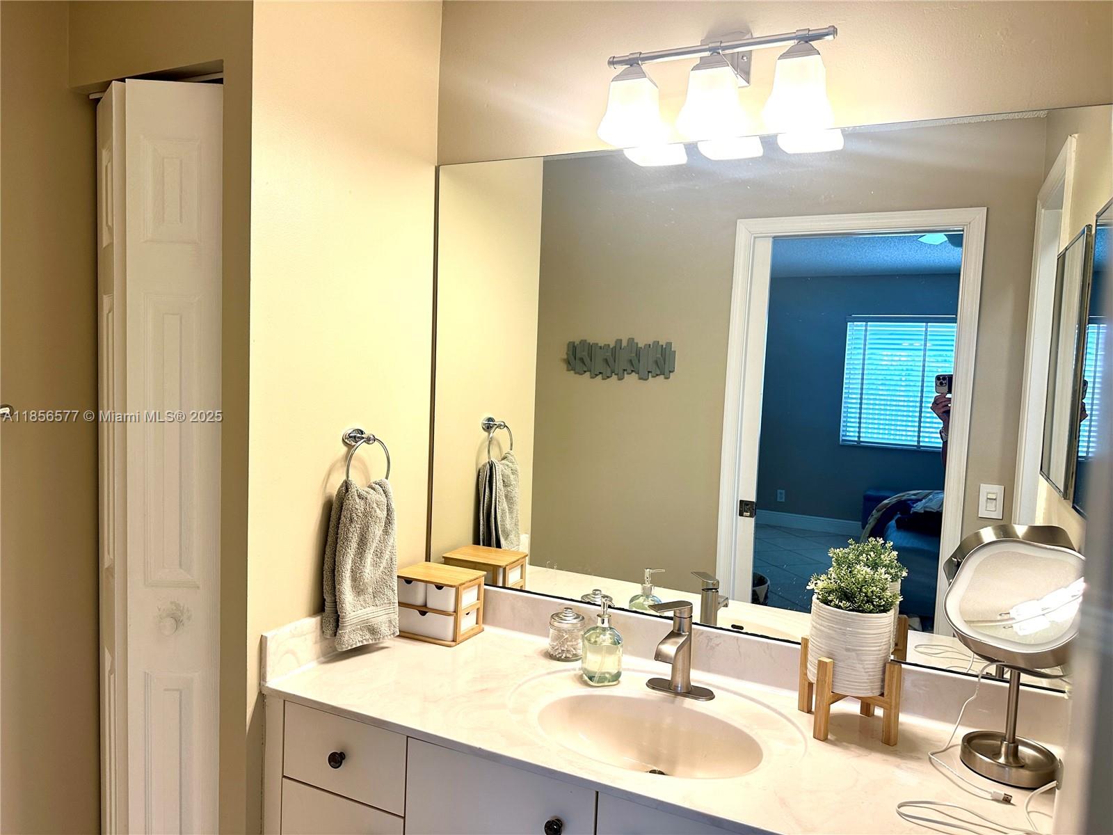 4370 Pine Ridge Court Weston, FL 33331 - Photo 15 of 39 a bathroom with a sink and a mirror