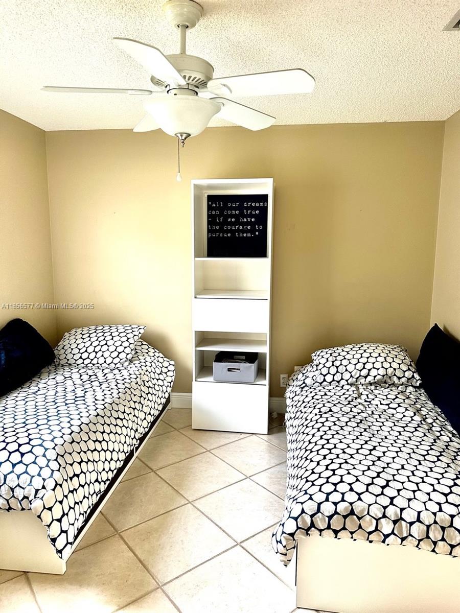 4370 Pine Ridge Court Weston, FL 33331 - Photo 26 of 39 a bedroom with a bed and a wall painting