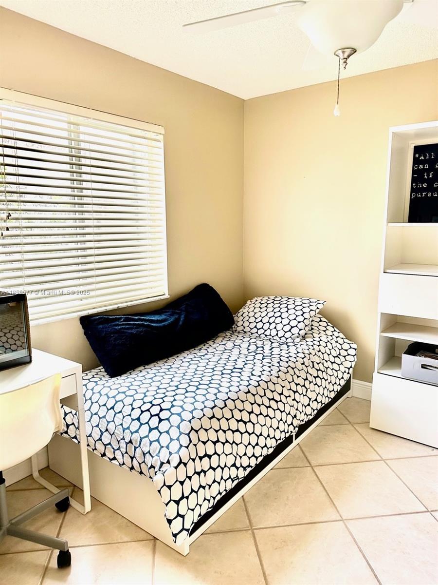 4370 Pine Ridge Court Weston, FL 33331 - Photo 27 of 39 a bedroom with a bed and wooden floor