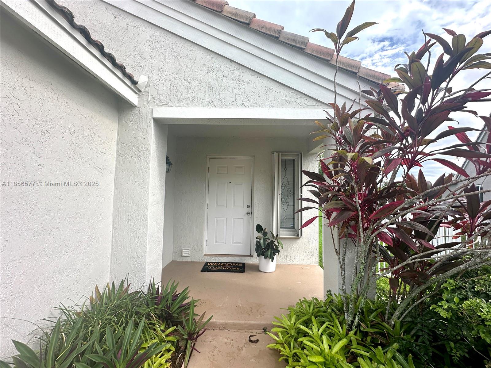 4370 Pine Ridge Court Weston, FL 33331 - Photo 3 of 39 a front view of a house with a yard