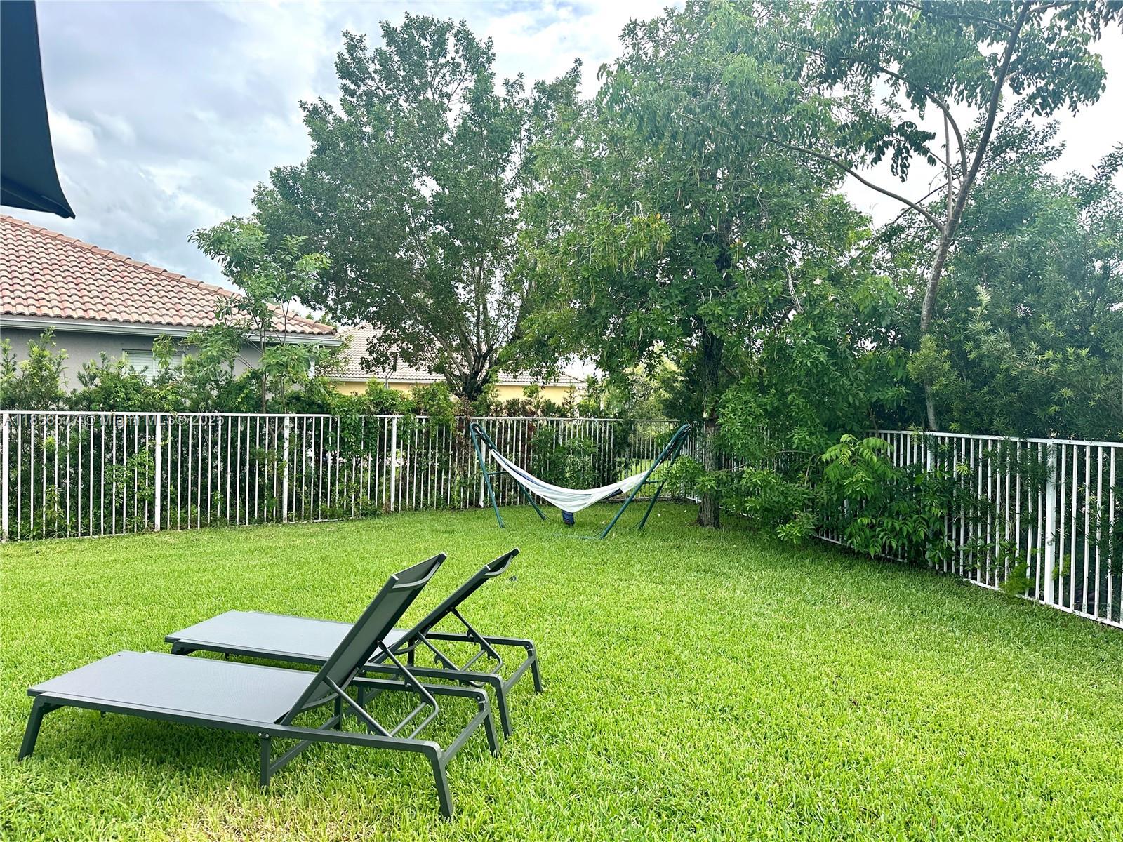 4370 Pine Ridge Court Weston, FL 33331 - Photo 35 of 39 a view of a backyard with table and chairs