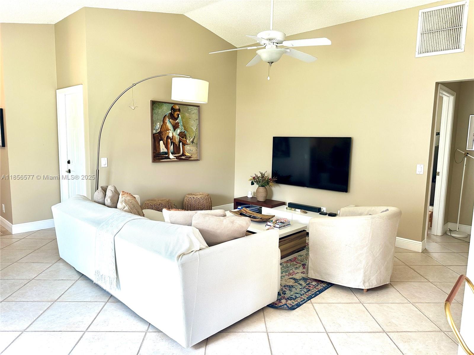 4370 Pine Ridge Court Weston, FL 33331 - Photo 6 of 39 a living room with a couch and a flat screen tv