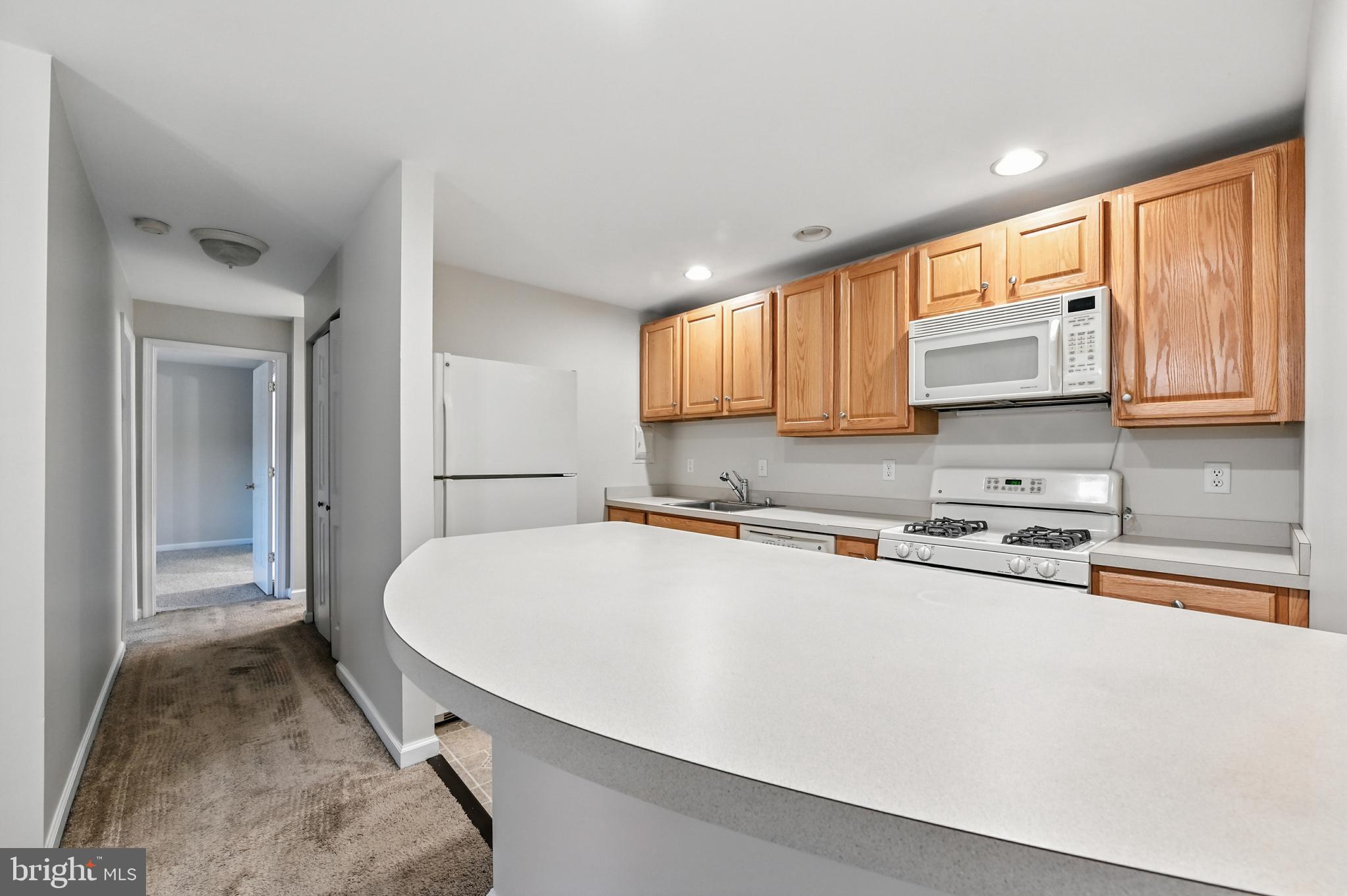 206 F Victor Parkway, Unit 206F Annapolis, MD 21403 - Photo 6 of 21 a kitchen with stainless steel appliances a refrigerator and a stove top oven