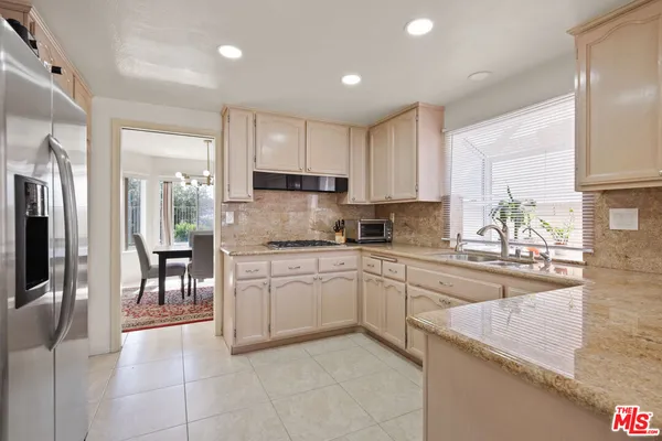 a kitchen with a sink window and cabinets
