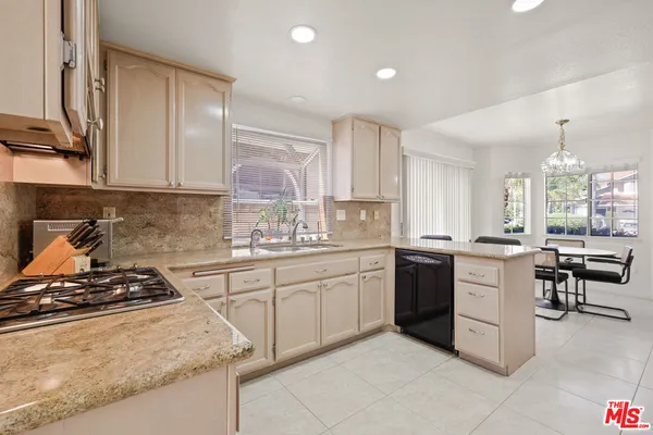 a kitchen with sink stove and cabinets