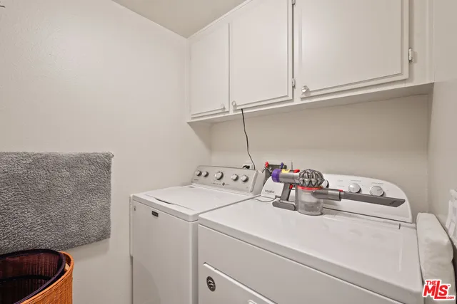 a view of walk in closet with clothes