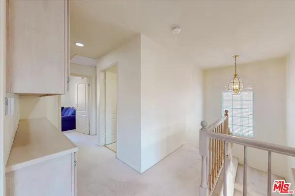 a view of a kitchen and an empty room