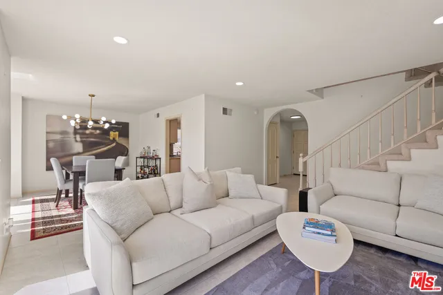 a kitchen with stainless steel appliances granite countertop a refrigerator and a stove
