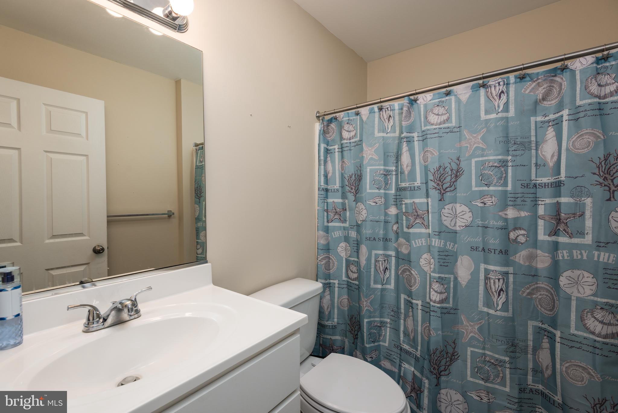 1 Oakview Court Ridgely, MD 21660 - Photo 14 of 26 a bathroom with a sink a toilet and shower curtain