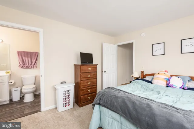 a bathroom with a sink vanity mirror and toilet