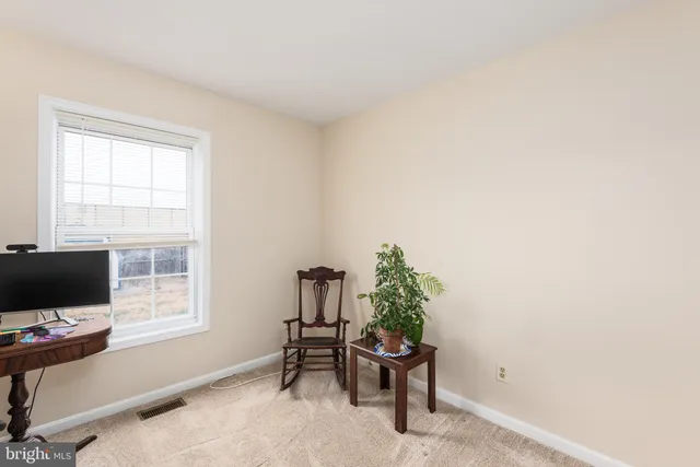 a view of a workspace with a window and chair
