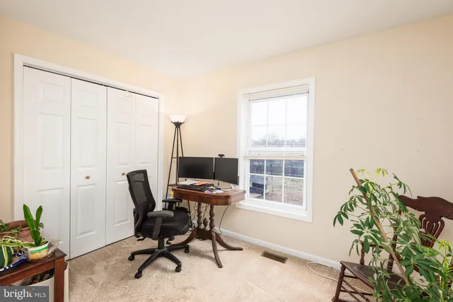 a view of a bedroom with cabinet and window