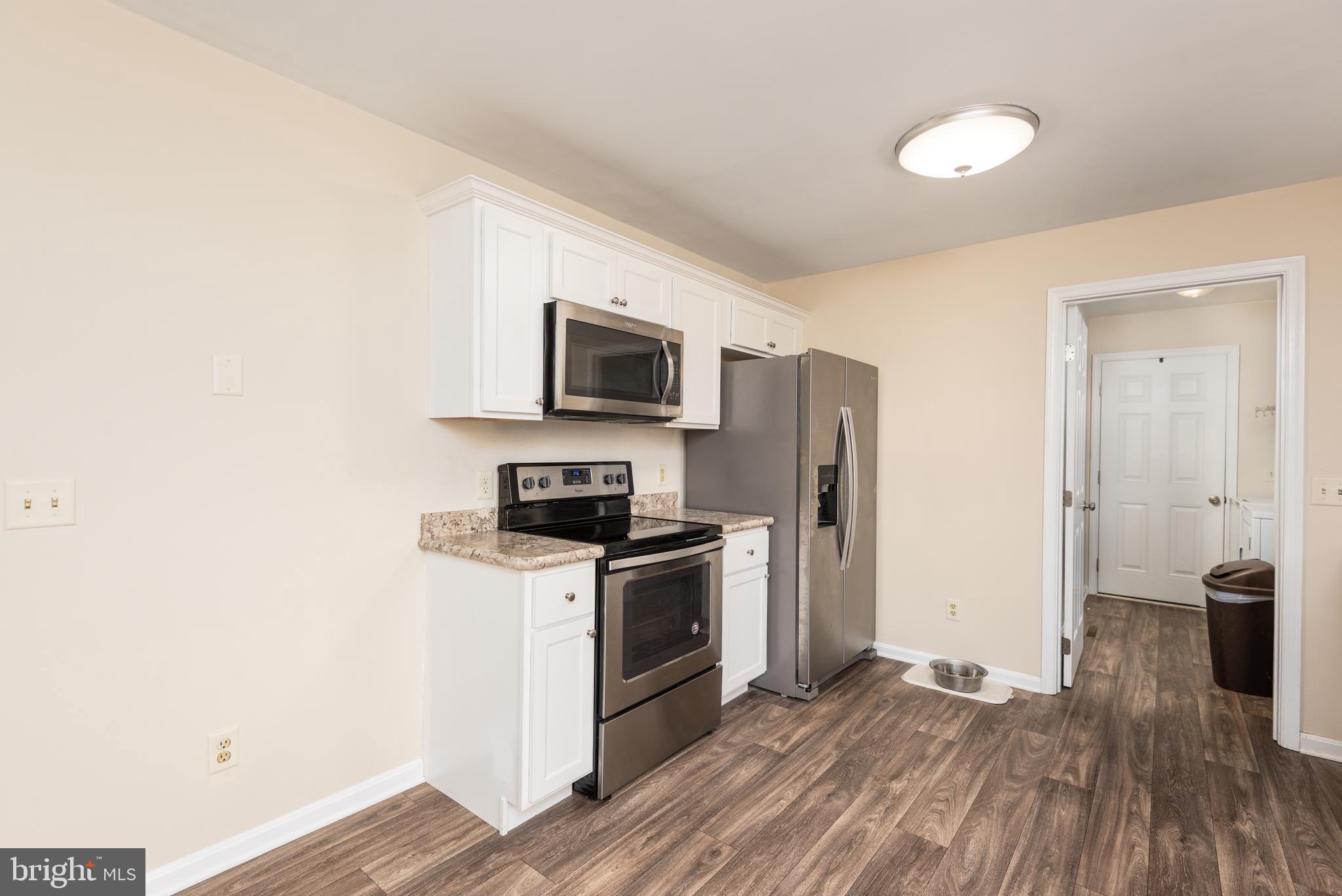 1 Oakview Court Ridgely, MD 21660 - Photo 8 of 26 a kitchen with a sink a microwave a refrigerator and cabinets