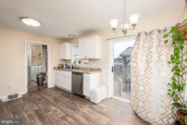 a kitchen with a sink stove top oven and refrigerator