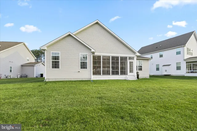 an aerial view of a house with swimming pool and a yard