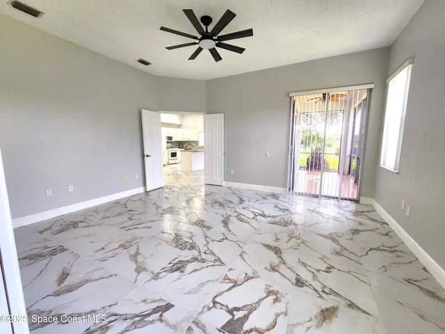 a large bathroom with a granite countertop tub a sink and a large mirror