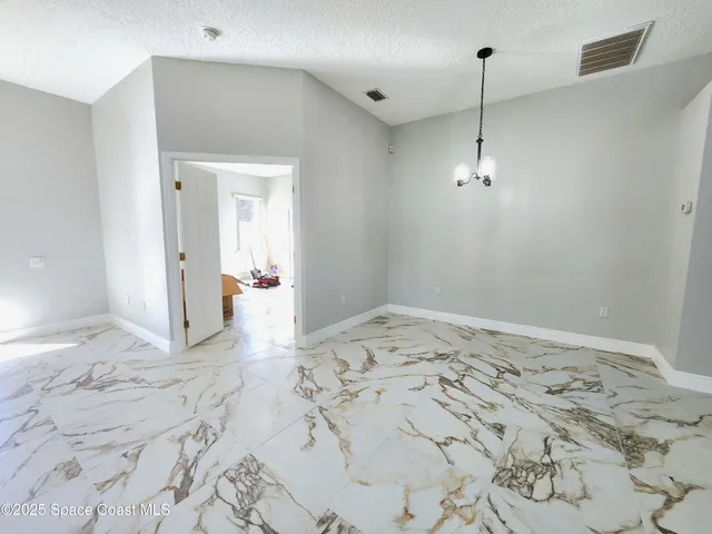 a kitchen with stainless steel appliances kitchen island granite countertop a refrigerator and a sink