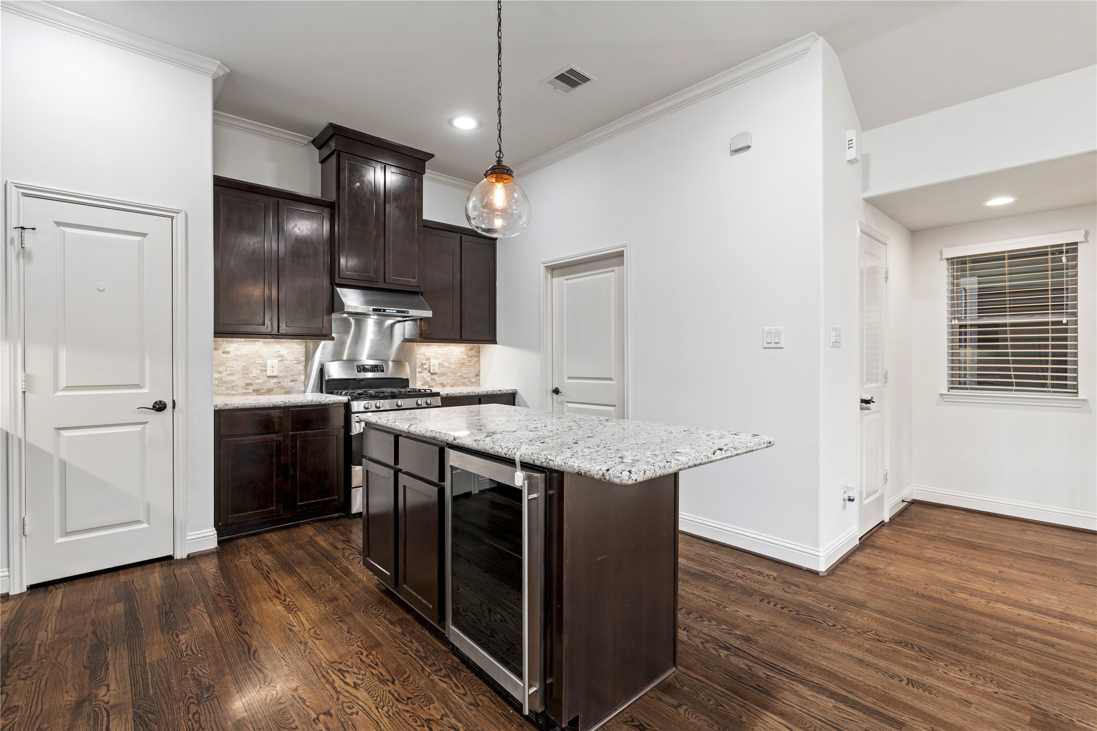 933 West 24th Street, Unit A Houston, TX 77008 - Photo 11 of 41 a kitchen with stainless steel appliances granite countertop wooden floors and sink