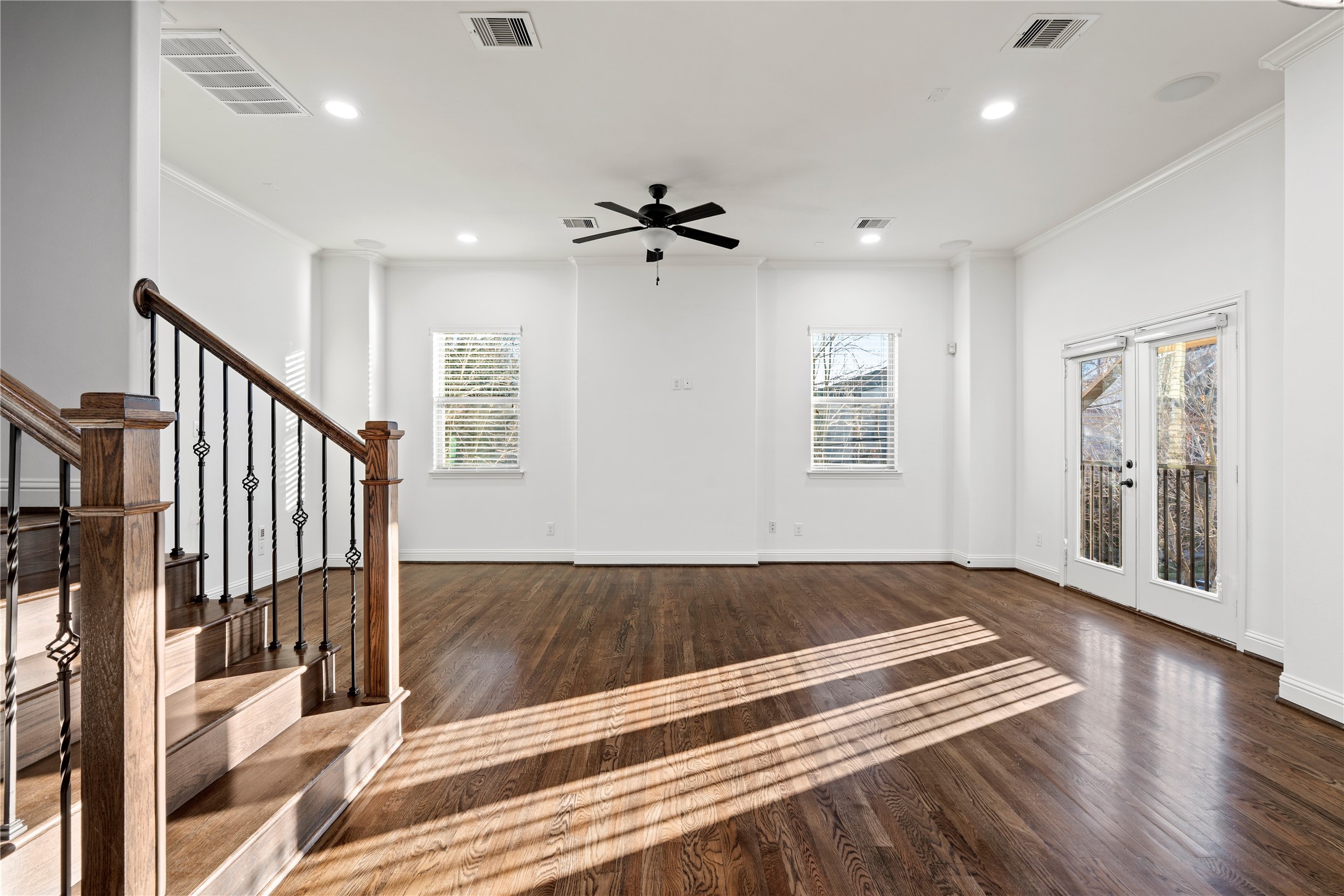 933 West 24th Street, Unit A Houston, TX 77008 - Photo 19 of 41 a view of an empty room with wooden floor and a ceiling fan