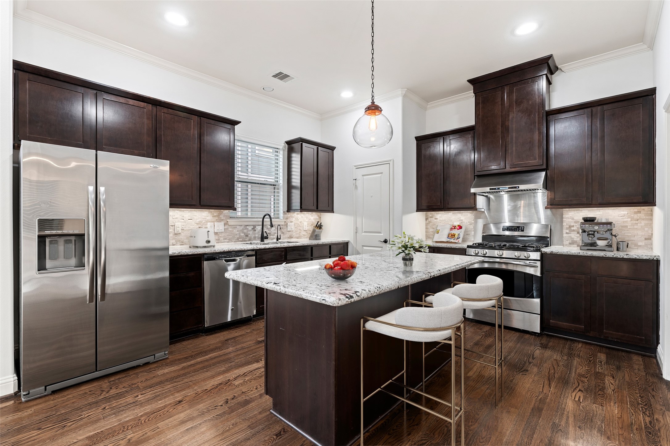 933 West 24th Street, Unit A Houston, TX 77008 - Photo 7 of 41 a kitchen with granite countertop stainless steel appliances a sink and refrigerator