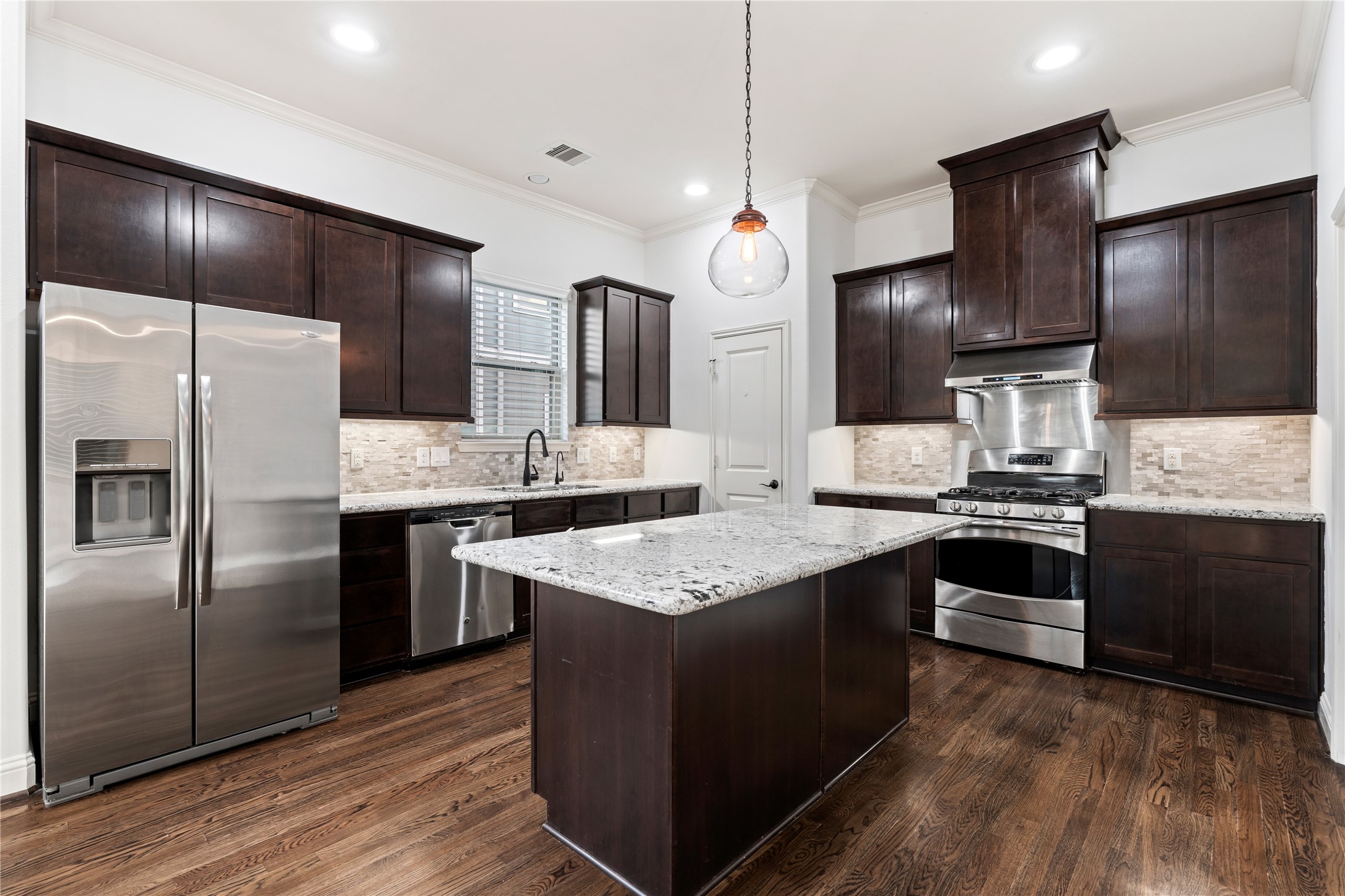 933 West 24th Street, Unit A Houston, TX 77008 - Photo 8 of 41 a kitchen with granite countertop stainless steel appliances and wooden cabinets