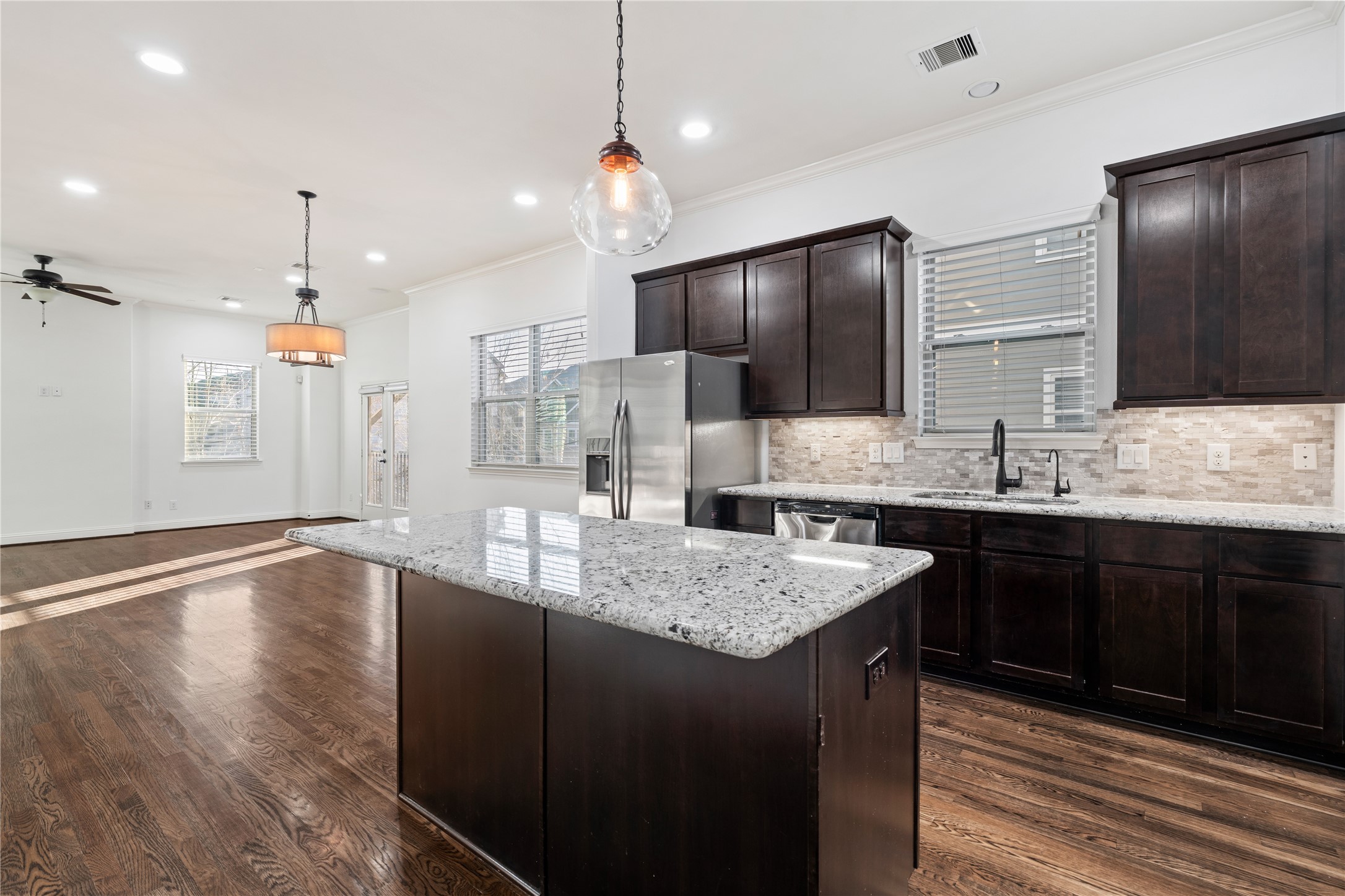 933 West 24th Street, Unit A Houston, TX 77008 - Photo 9 of 41 a kitchen with kitchen island granite countertop a sink stove and refrigerator