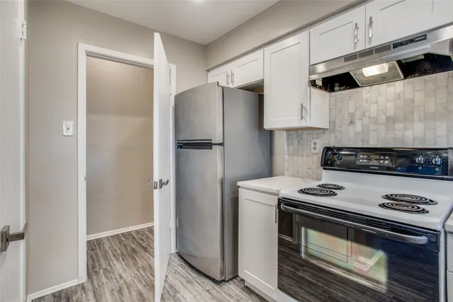 a kitchen with a sink cabinets and stainless steel appliances