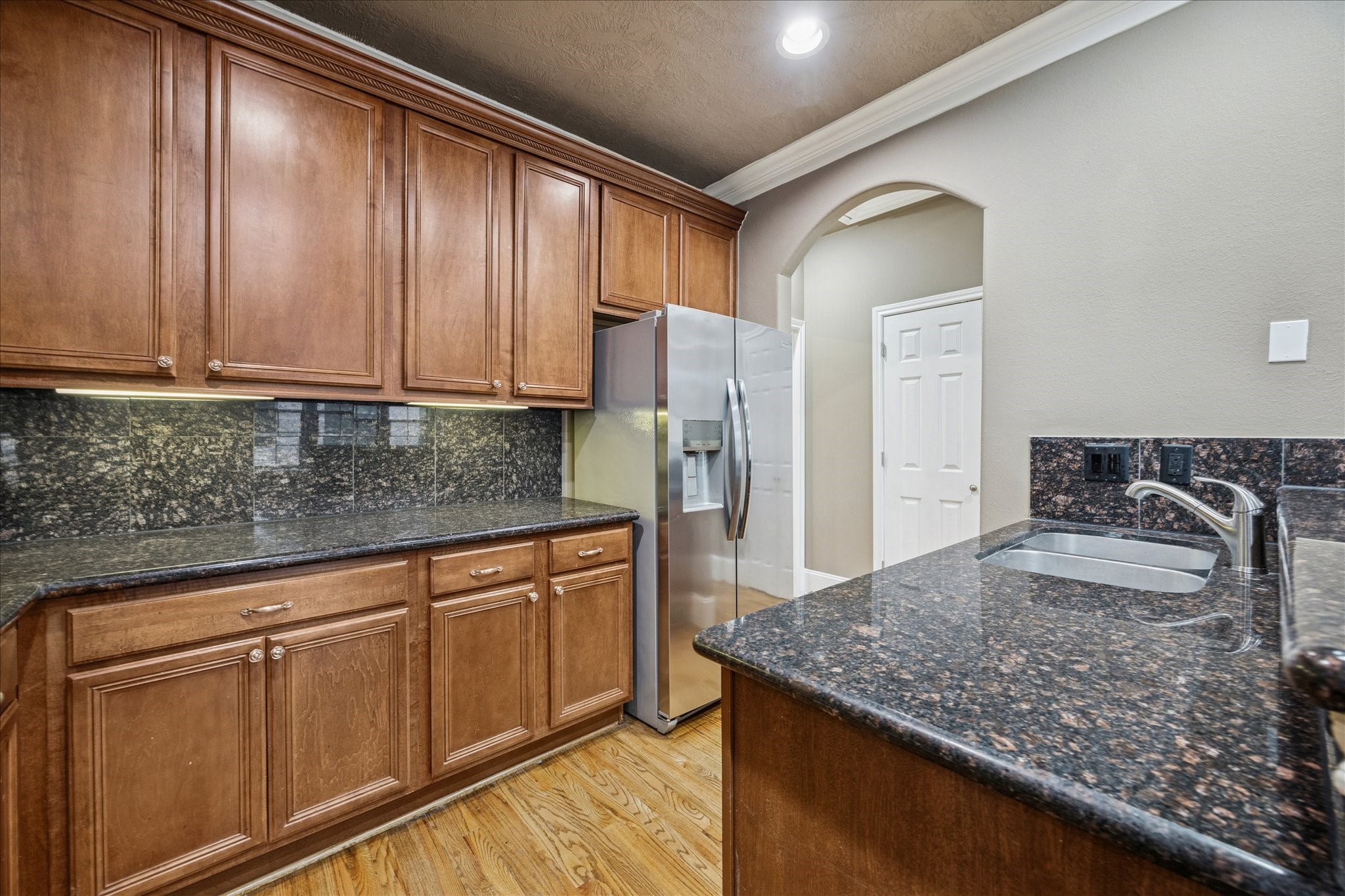 1376 Studer Street Houston, TX 77007 - Photo 12 of 38 a kitchen with stainless steel appliances granite countertop a sink and refrigerator
