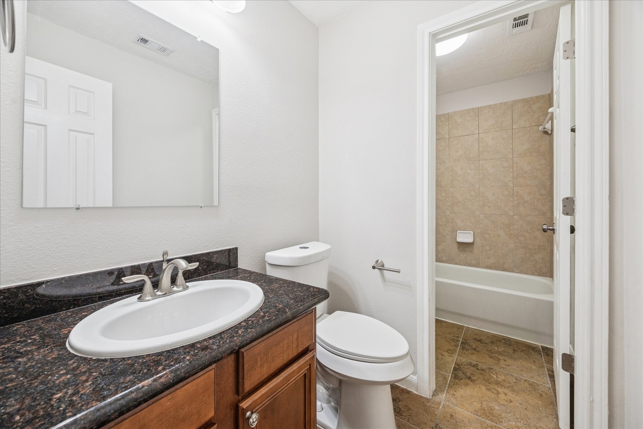 1376 Studer Street Houston, TX 77007 - Photo 26 of 38 a bathroom with a granite countertop sink toilet and shower