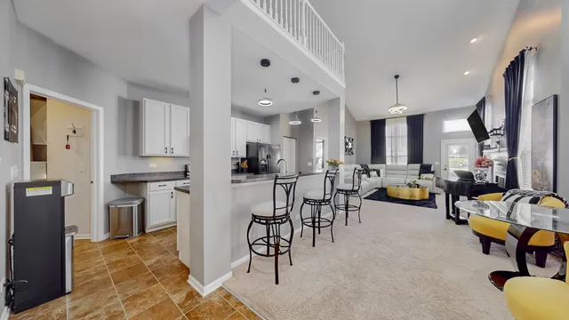 a kitchen with stainless steel appliances kitchen island granite countertop a refrigerator and microwave