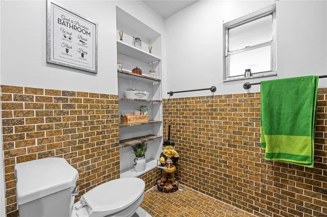 a view of walk in closet with clothes