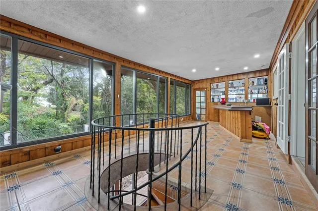 a room that has a bed and a wooden floor