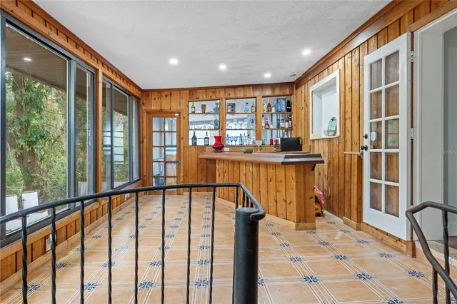 a living room with furniture a ceiling fan and a large window