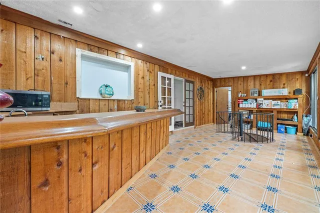 a kitchen with stainless steel appliances granite countertop a refrigerator and a stove